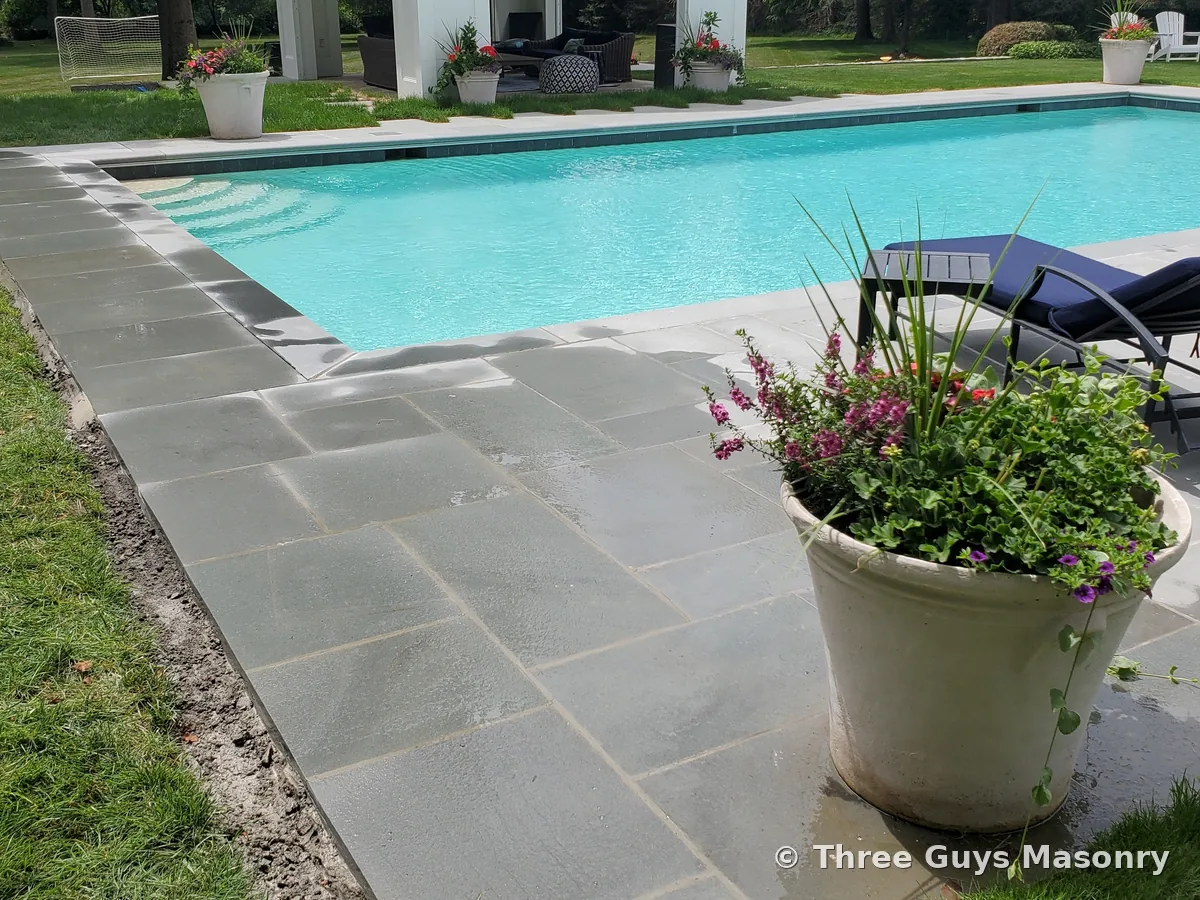 Bluestone pool coping after Three Guys Masonry renovation